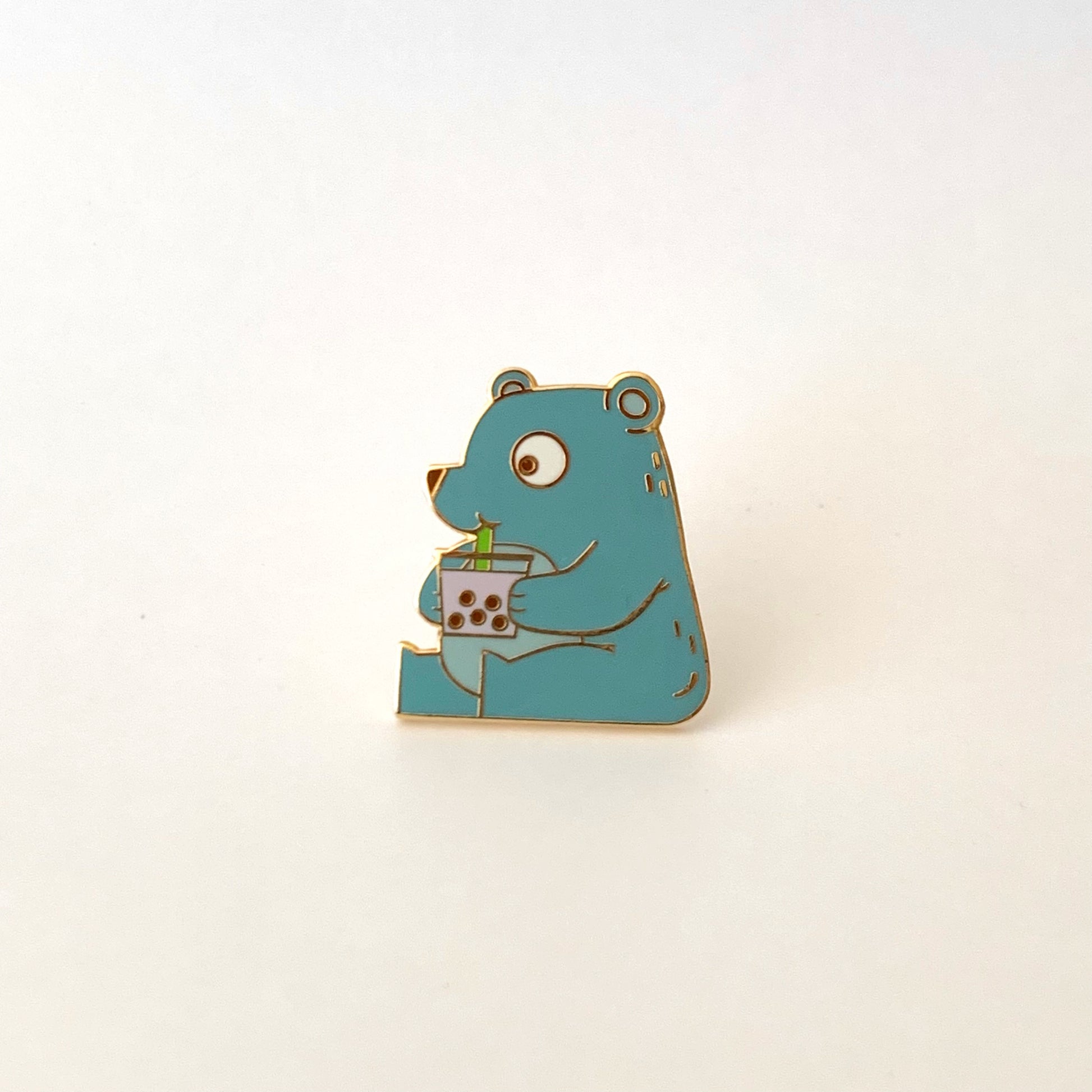 pin of a cute bear drinking boba 