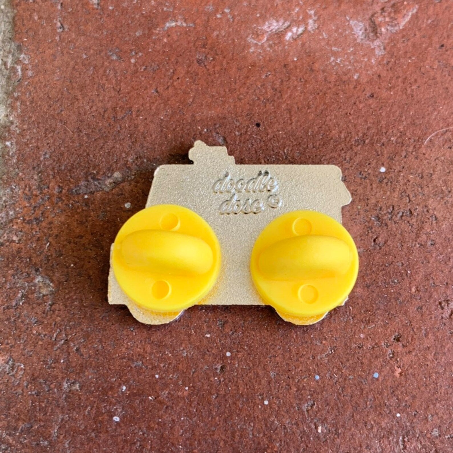 back of pin shows double rubber pin backs