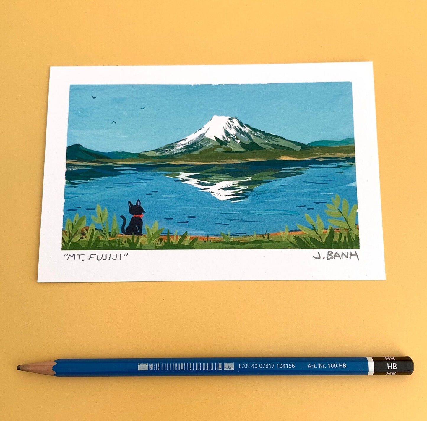 a cat looking at mt fuji the size of a pencil