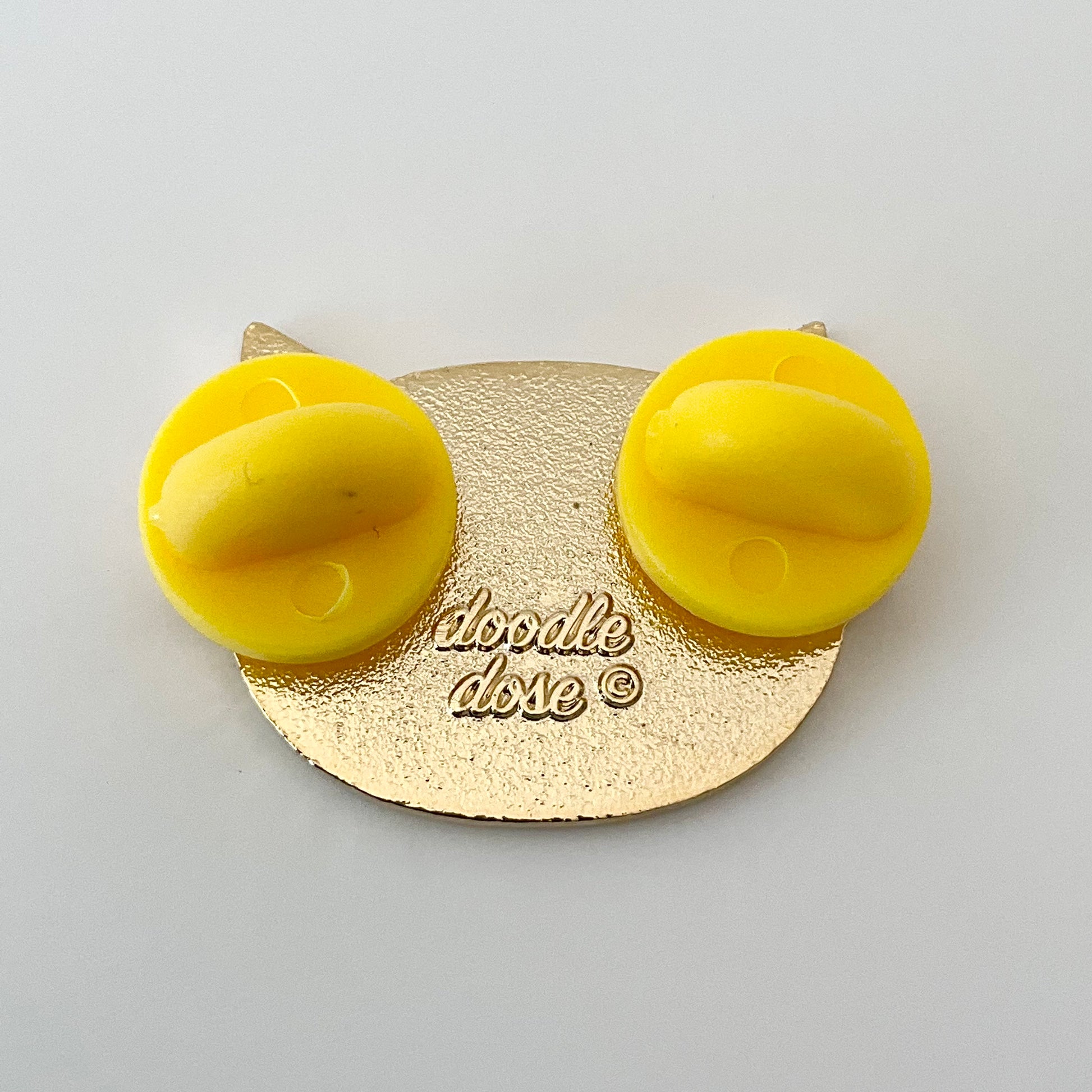 back of the pin showing two rubber pin backs
