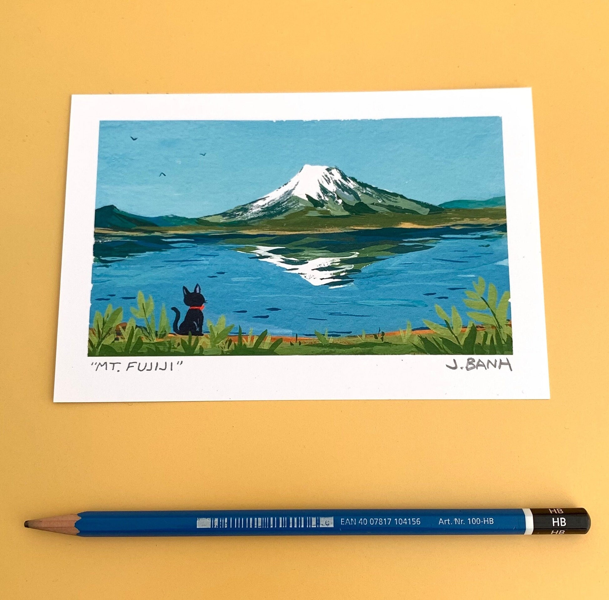 a cat looking at mt fuji the size of a pencil